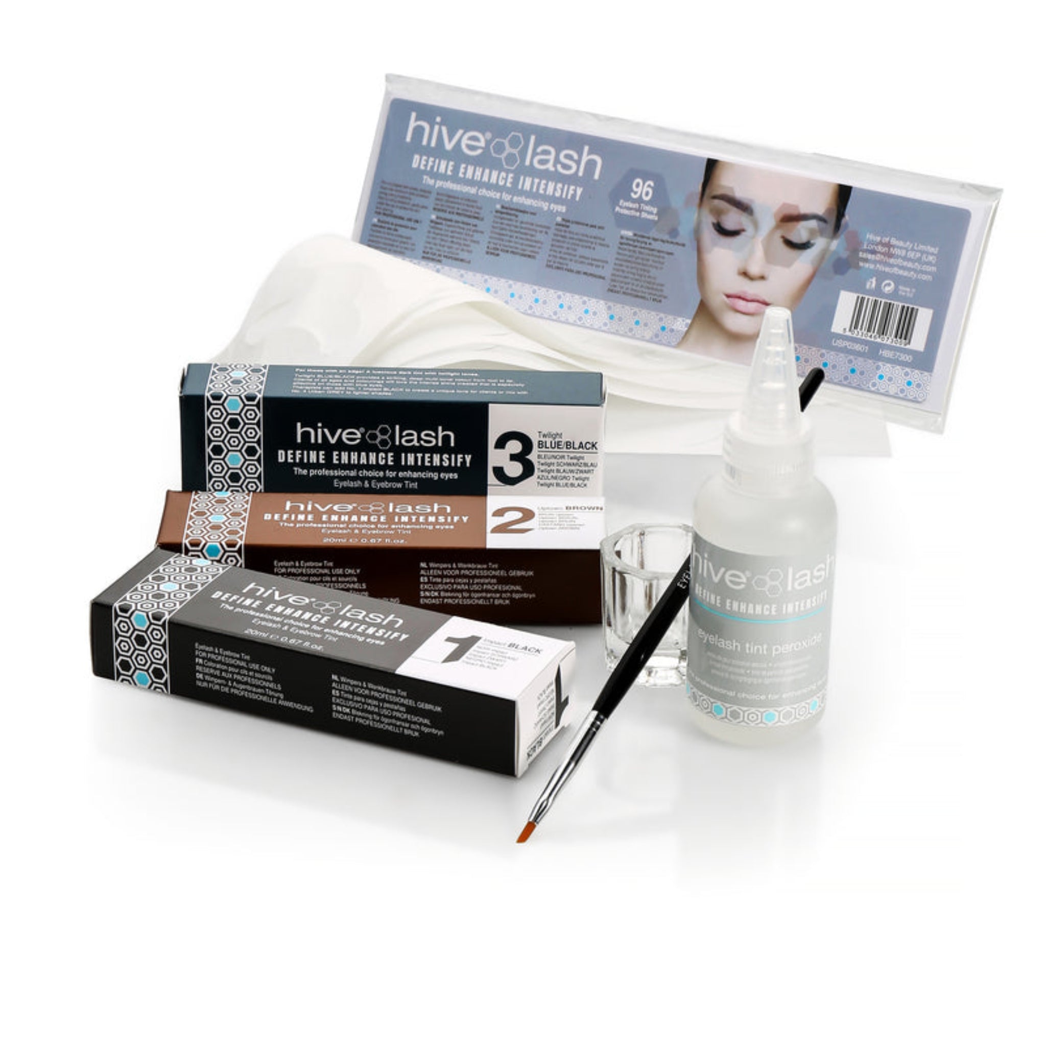 Hive Lash Define Enhance Intensify Eyelash Tinting Starter Kit contents flatlay showing three Hive Lash tint boxes in Impact Black Uptown Brown and Twilight Blue Black shades alongside a Hive Lash Eyebrow Tint Peroxide 20ml bottle a fine precision tint brush a clear glass mixing dish and a pack of 96 Hive Lash lint-free eye shields from diagonal angle on white background