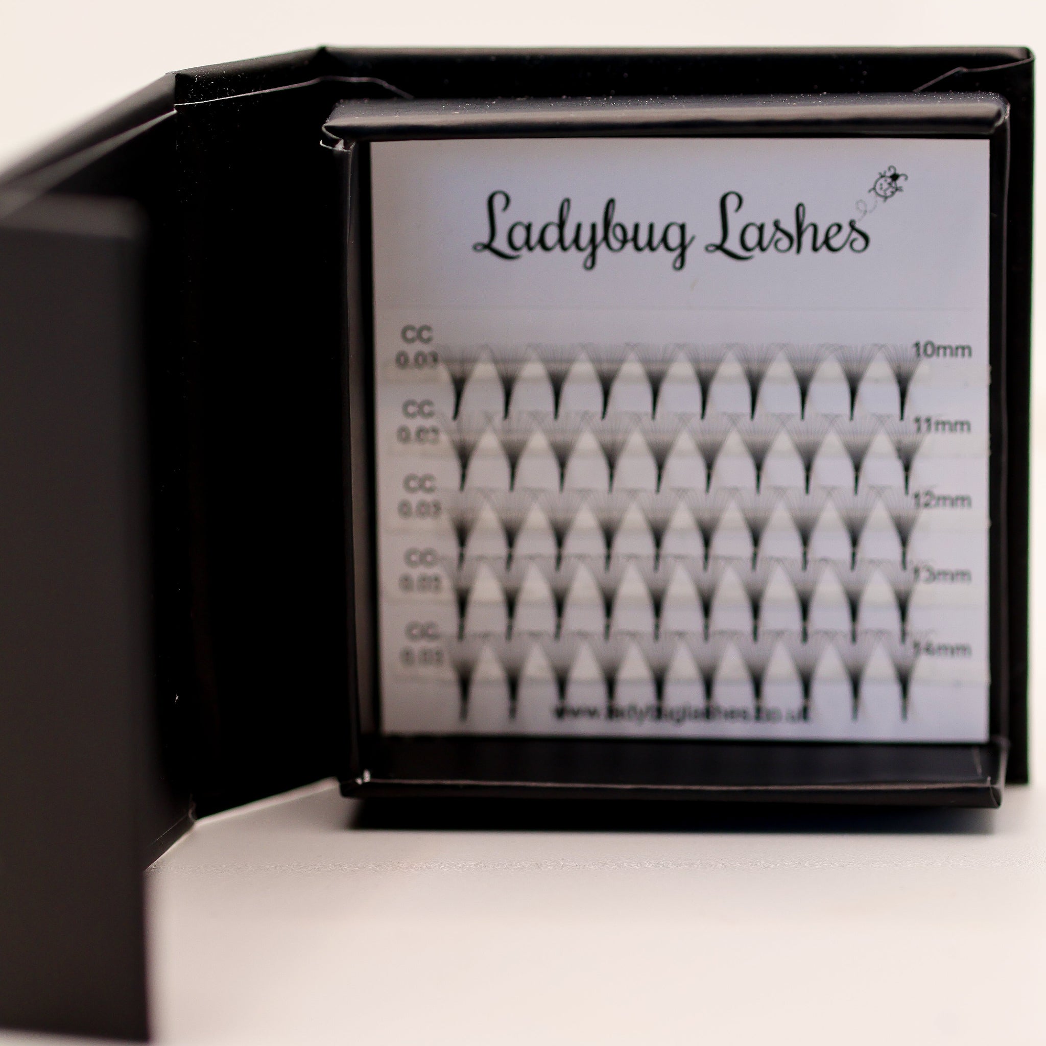 1. Ladybug Lashes Sample Tray Platinum Promade Ultra Black open in branded box showing multiple curl and dimension options front-facing view