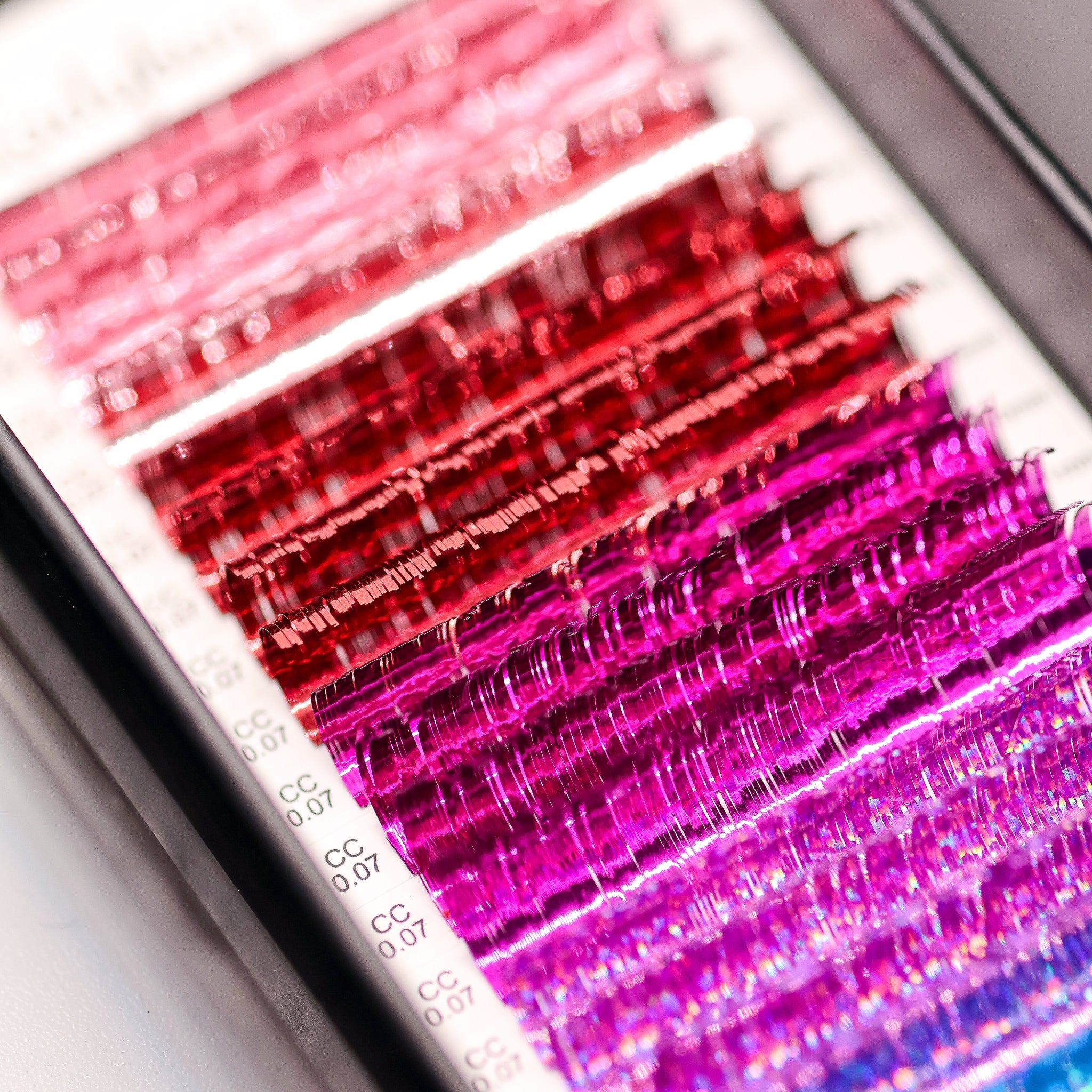 Close-up of Ladybug Lashes YY and Tinsel Lash Collection showing shimmering tinsel lash fibres and colour detail