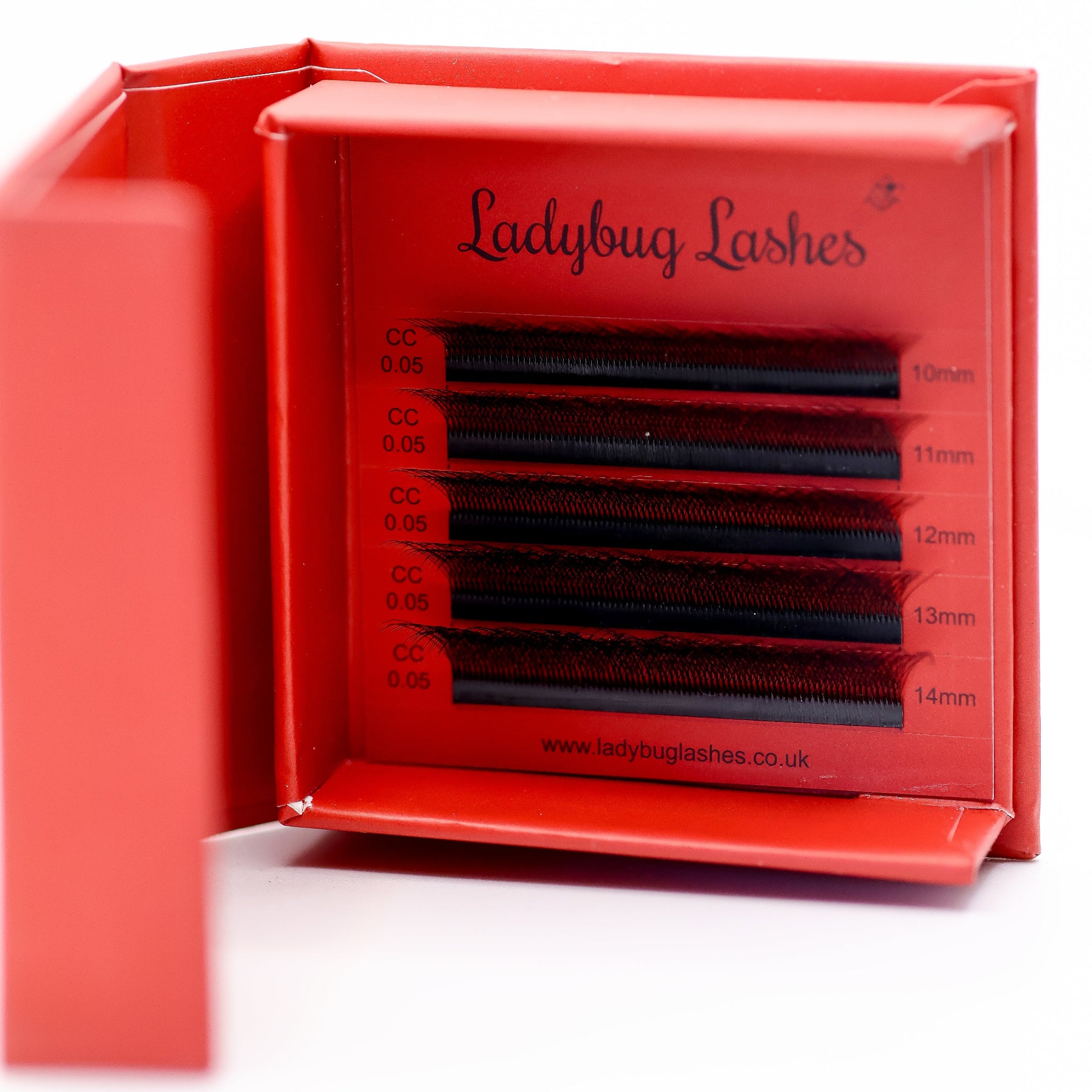 Ladybug Lashes Sample Tray 6D Clover open showing five rows CC curl 0.05 in mixed lengths 10–14mm in red branded box