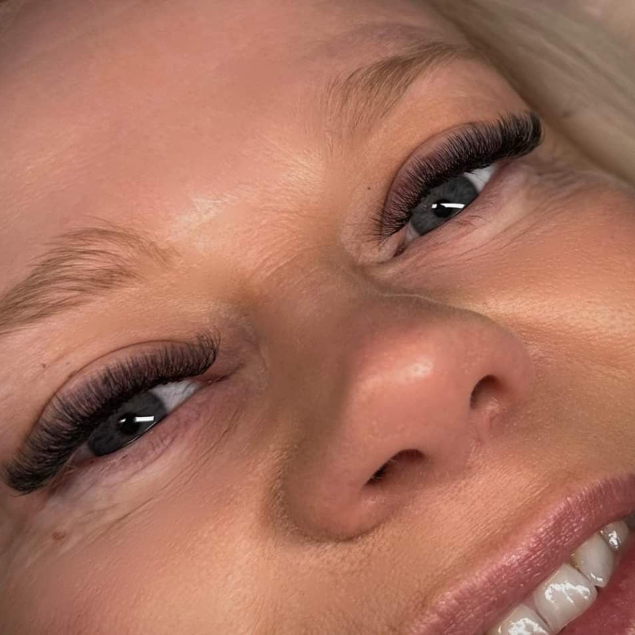 Completed Ladybug Lashes 6D Clover set on both eyes showing dense black volume and dramatic curl from overhead angle