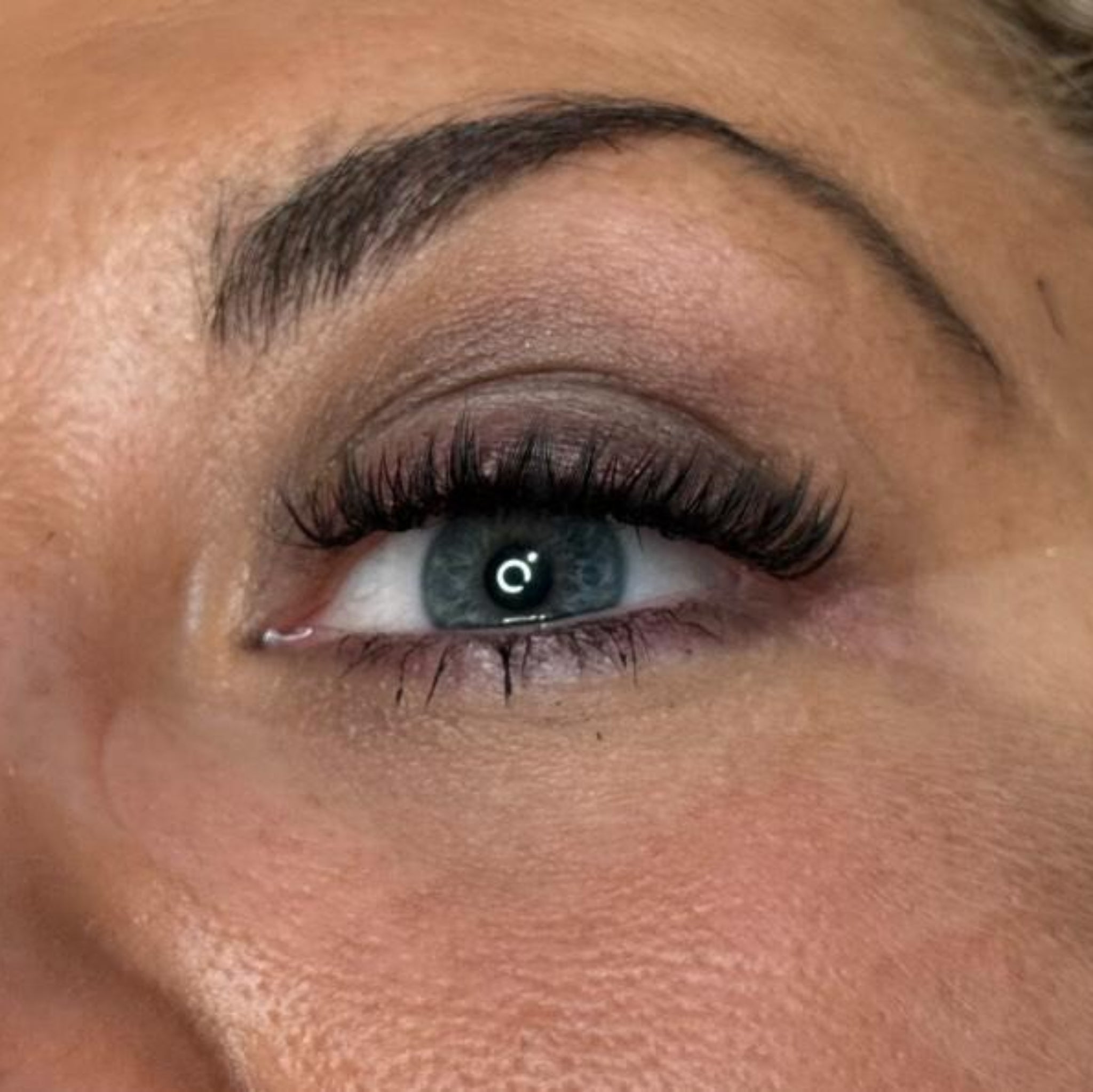 Completed Anime Feather lash extension set on blue-grey eye with smoky eye makeup showing dramatic feather spike volume ladybug lashes