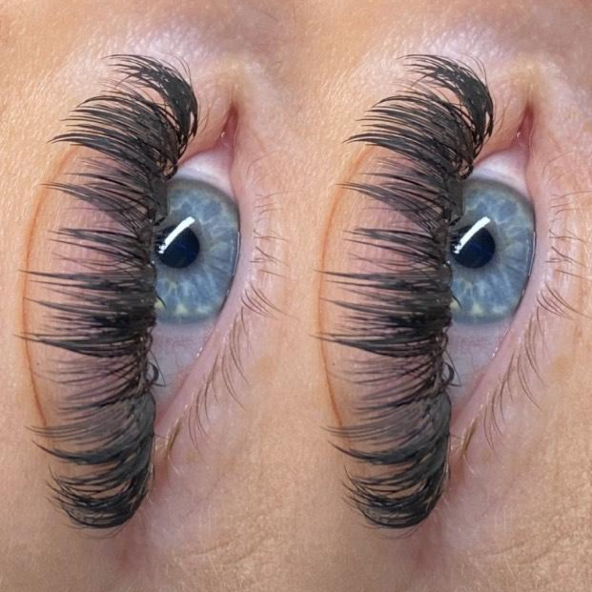 10. Extreme close-up side view of Anime Feather lash extension set on blue-grey eye showing dramatic feather spike definition