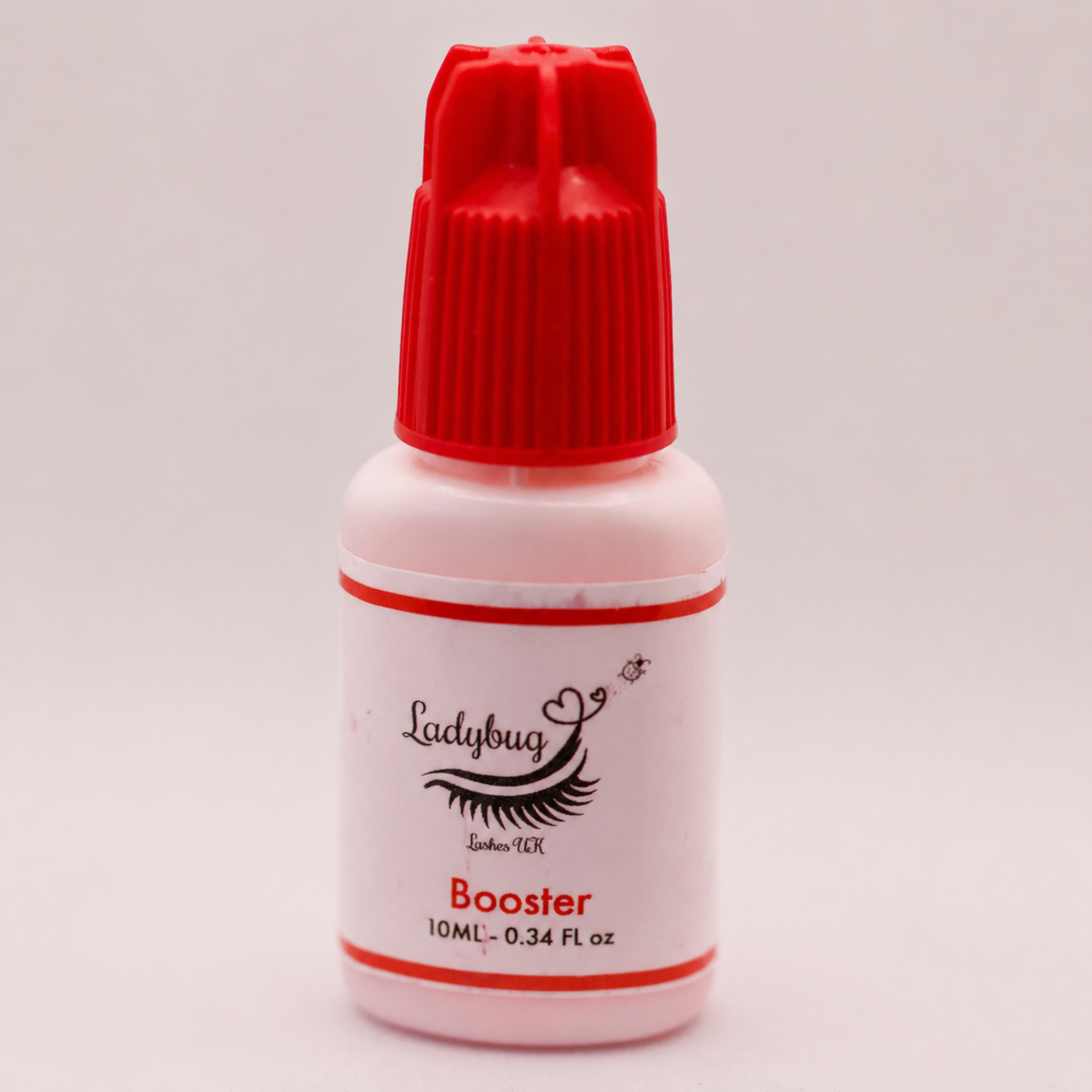 Ladybug Lashes Lash Glue Retention Booster 10ml white plastic bottle with red cap showing product label with Ladybug Lashes UK Booster branding and 10ML 0.34 FL oz size detail on a light grey background