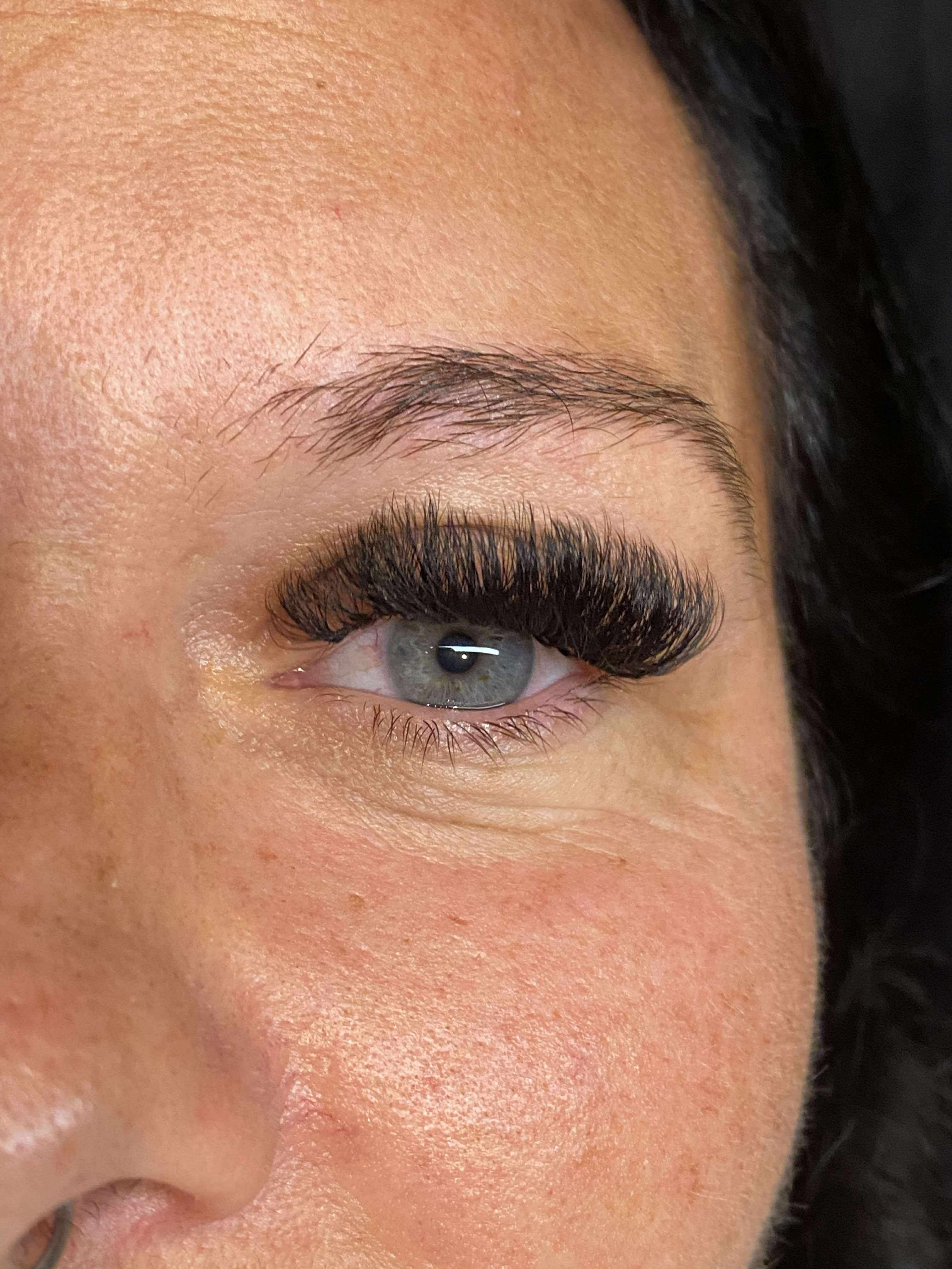 Close-up of a person's eye with long eyelashes
