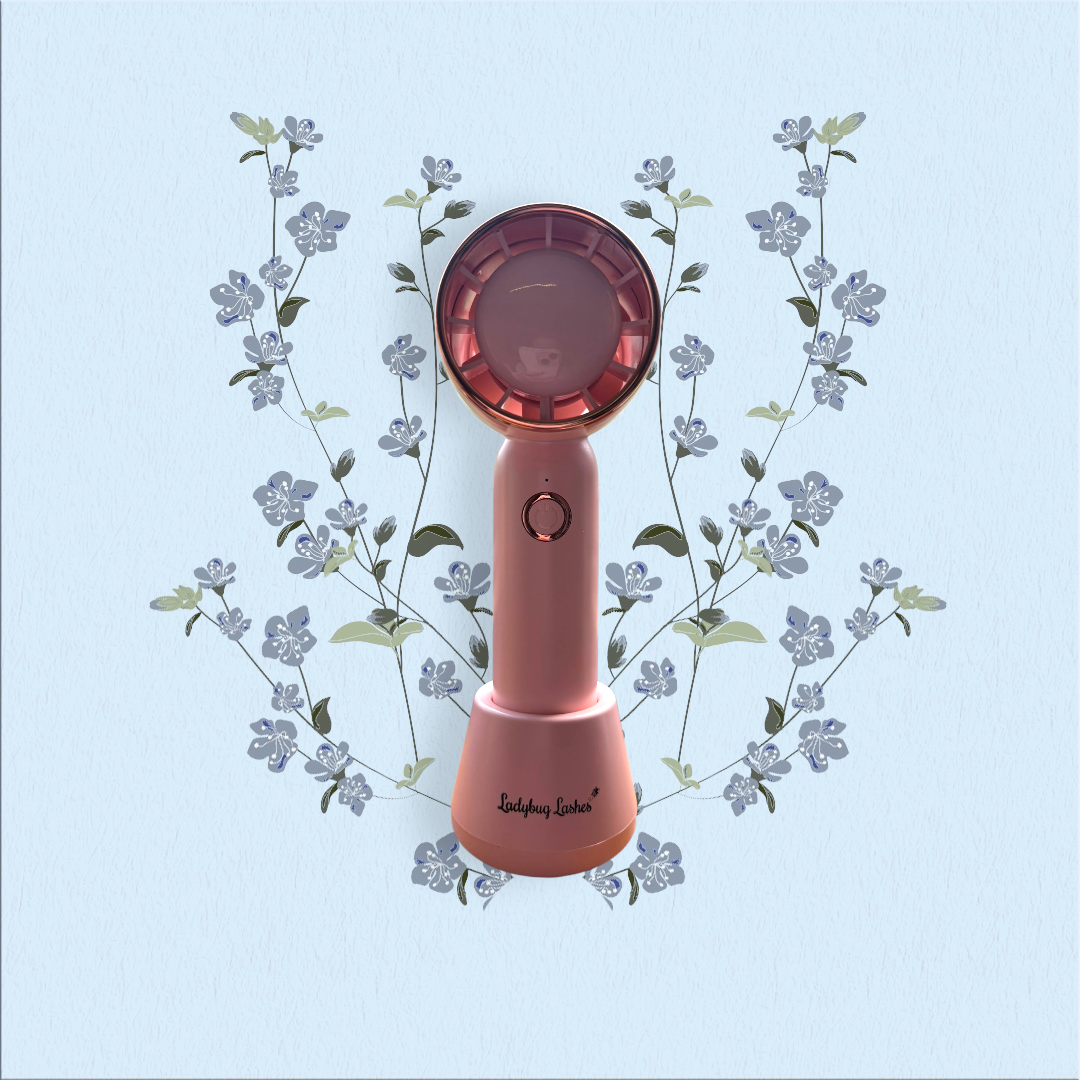 Pink handheld device with floral design on a light blue background