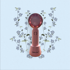 Pink handheld device with floral design on a light blue background