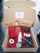 A box of Ladybug Lashes brand false eyelashes and accessories, including bamboo applicator wands, mascara spoolies, and lash shampoo, displayed on a red foam base.