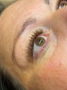 Close-up of a person's eye with visible eyelashes and skin texture.