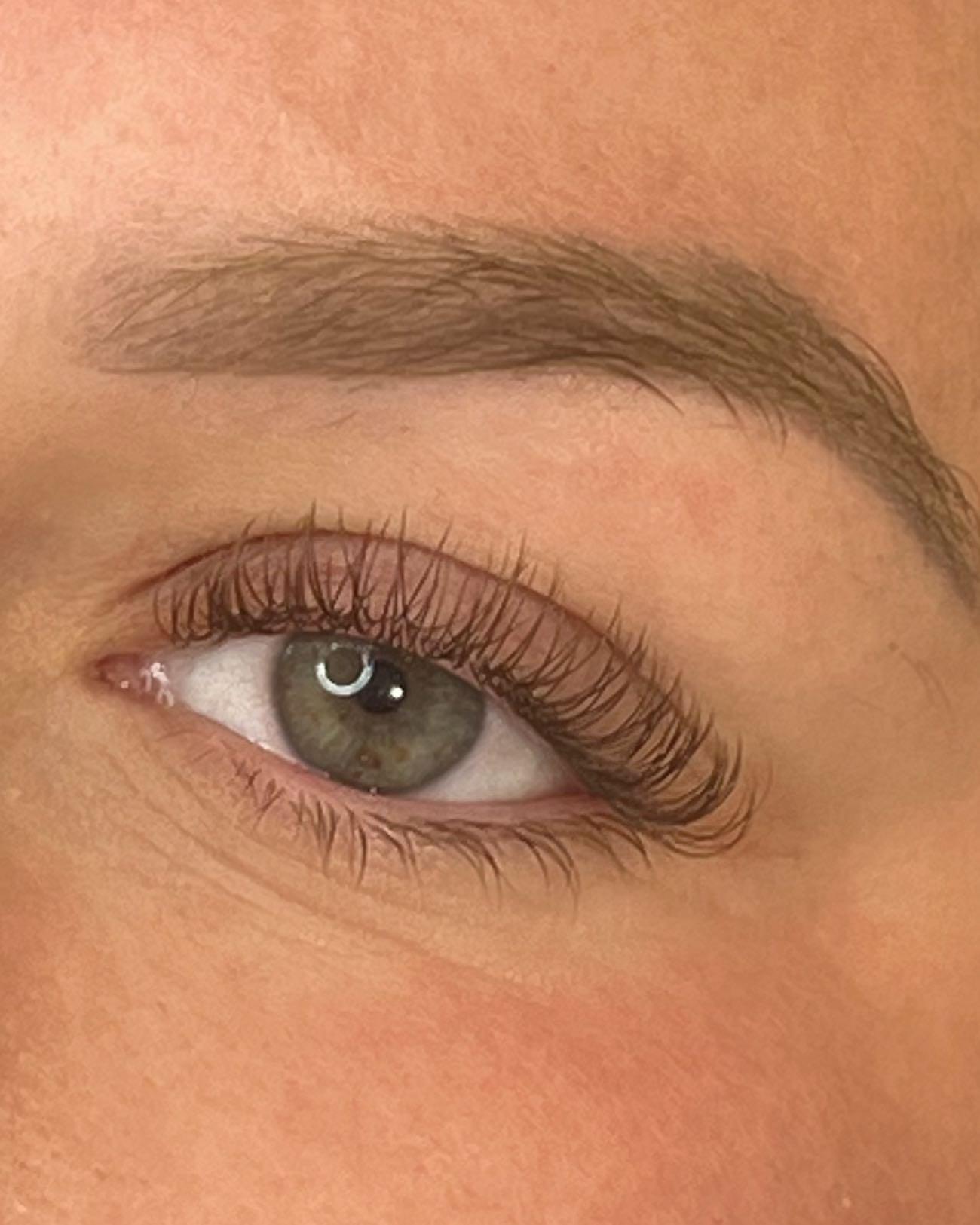 A close-up image of an eye with an extended eyelash application, showcasing the product's effect on enhancing the eyelashes.
