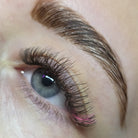 Completed Ladybug Lashes YY and Tinsel lash set on blue eye showing dense volume with holographic blue tinsel fibres from side angle
