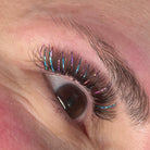Completed Ladybug Lashes YY and Tinsel lash set on hazel eye showing coloured volume lashes with iridescent shimmer from front angle