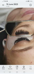 Close-up of eyelash extension application.