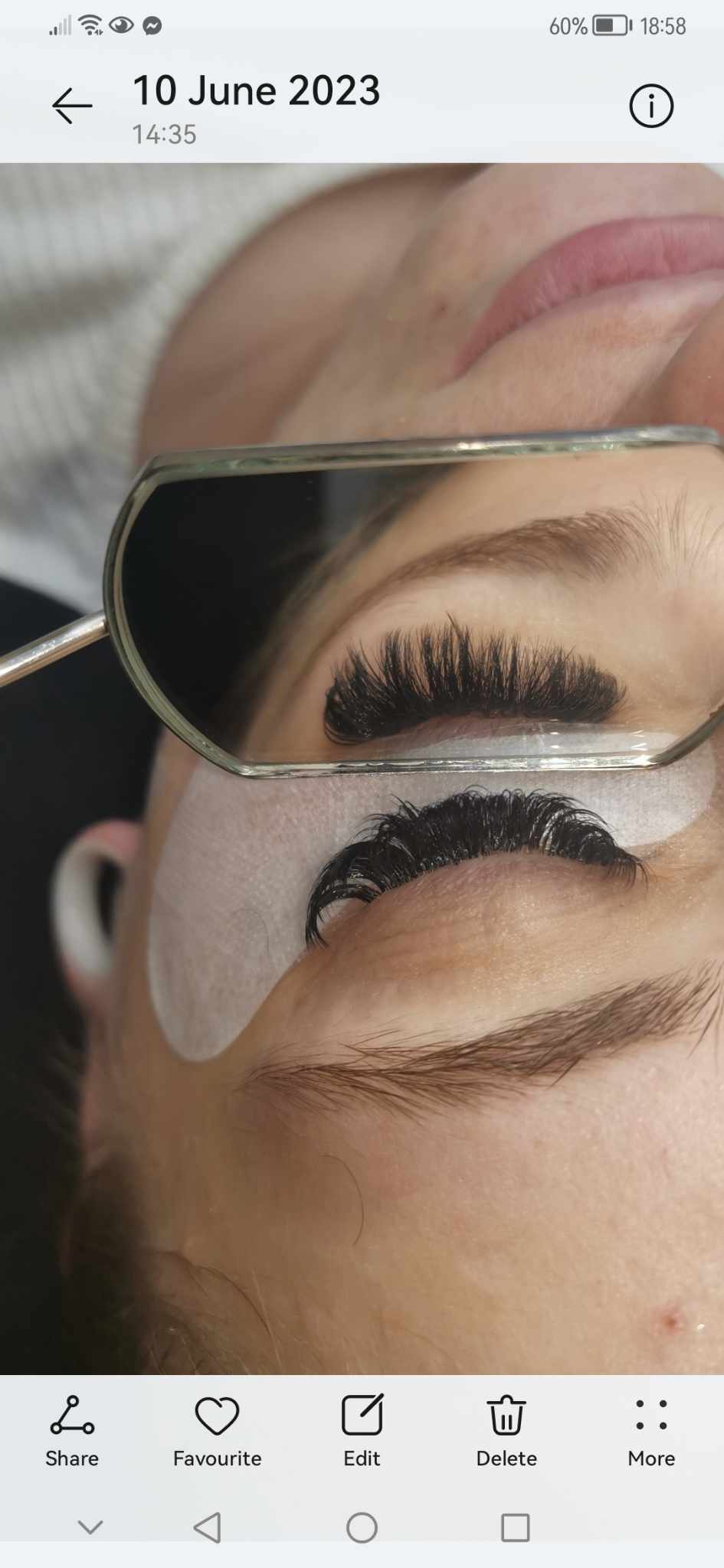 Close-up of eyelash extension application.