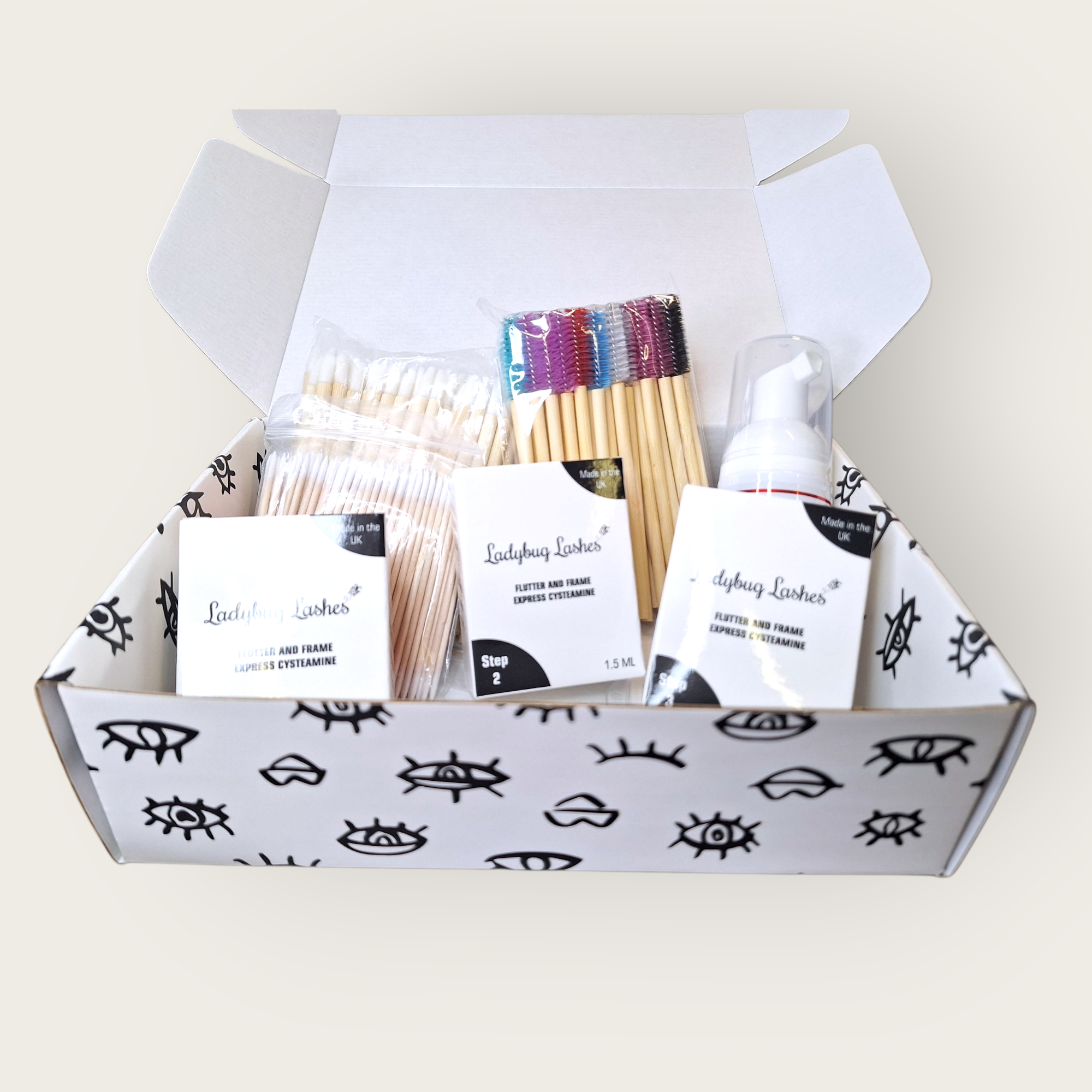 Box of Ladyfish Lashes products including cotton swabs, applicators, and a spray bottle on a white background.