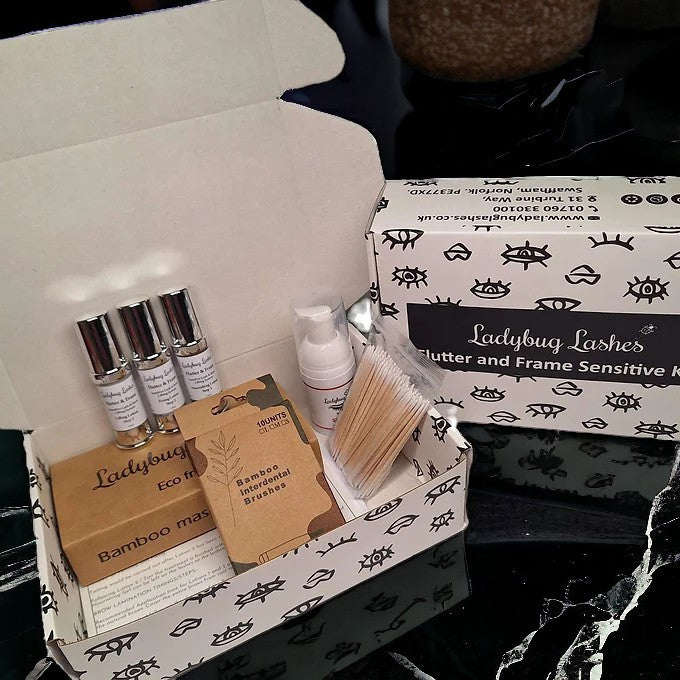 The image shows the contents of the Flutter and Frame Sensitive Brow Lamination Kit, which includes bottles, applicators, and brushes neatly arranged inside an open box with a black and white animal print.