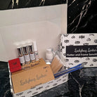 A Flutter and Frame Sensitive Lash Lift Kit by Ladybug Lashes, displayed with various components such as bottles, tools, and lashes on a marble surface.
