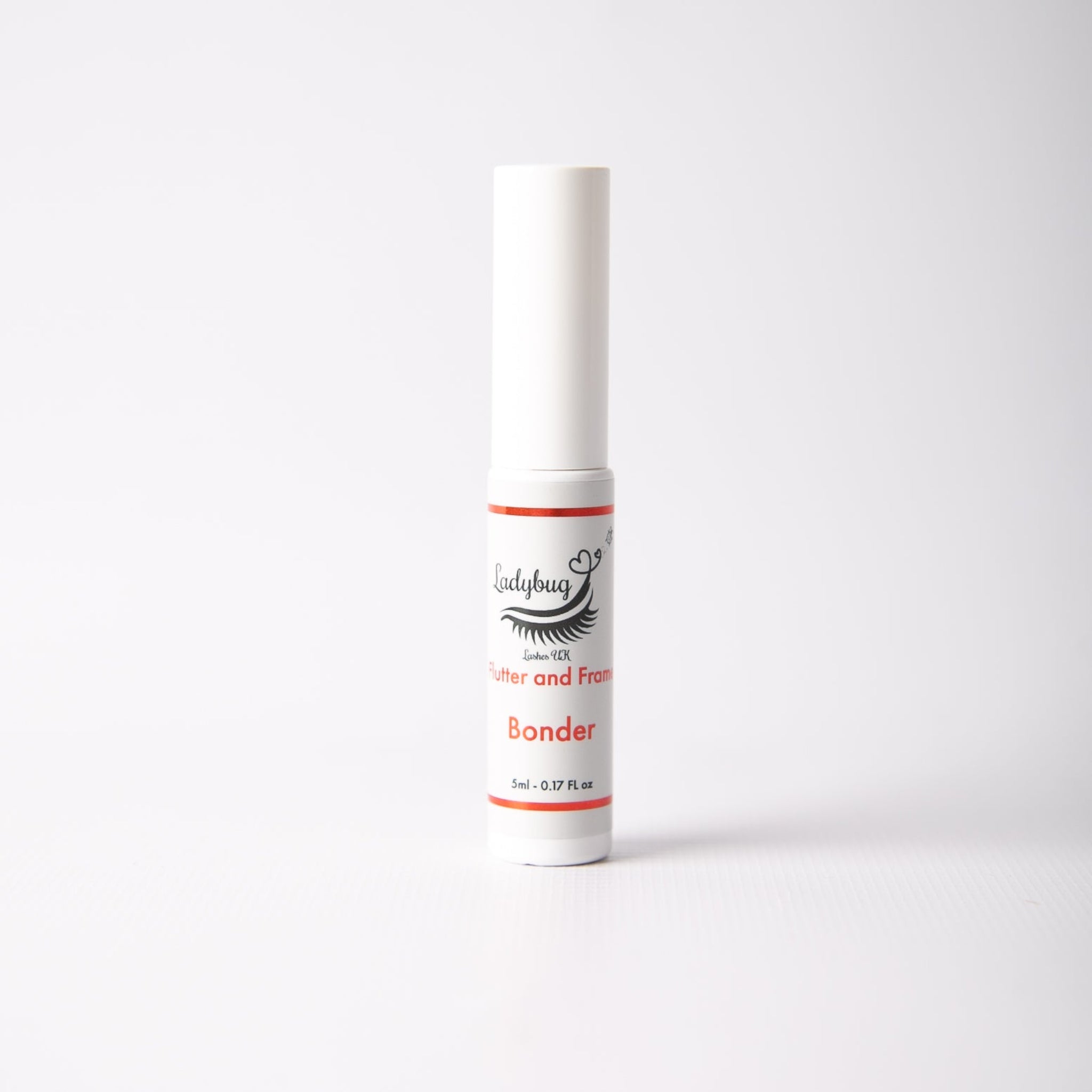 Ladybug Lashes UK Lash Lift Bonder 5ml white slim tube with white cap showing product label with Ladybug Lashes UK lash icon branding, "Butter and Frame Bonder" text in red and 5ml 0.17 FL OZ size detail, photographed straight-on against a light grey background