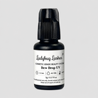A bottle of Ladybug Lashes Dew Drop UV cosmetic-grade beauty system on a light gray background.