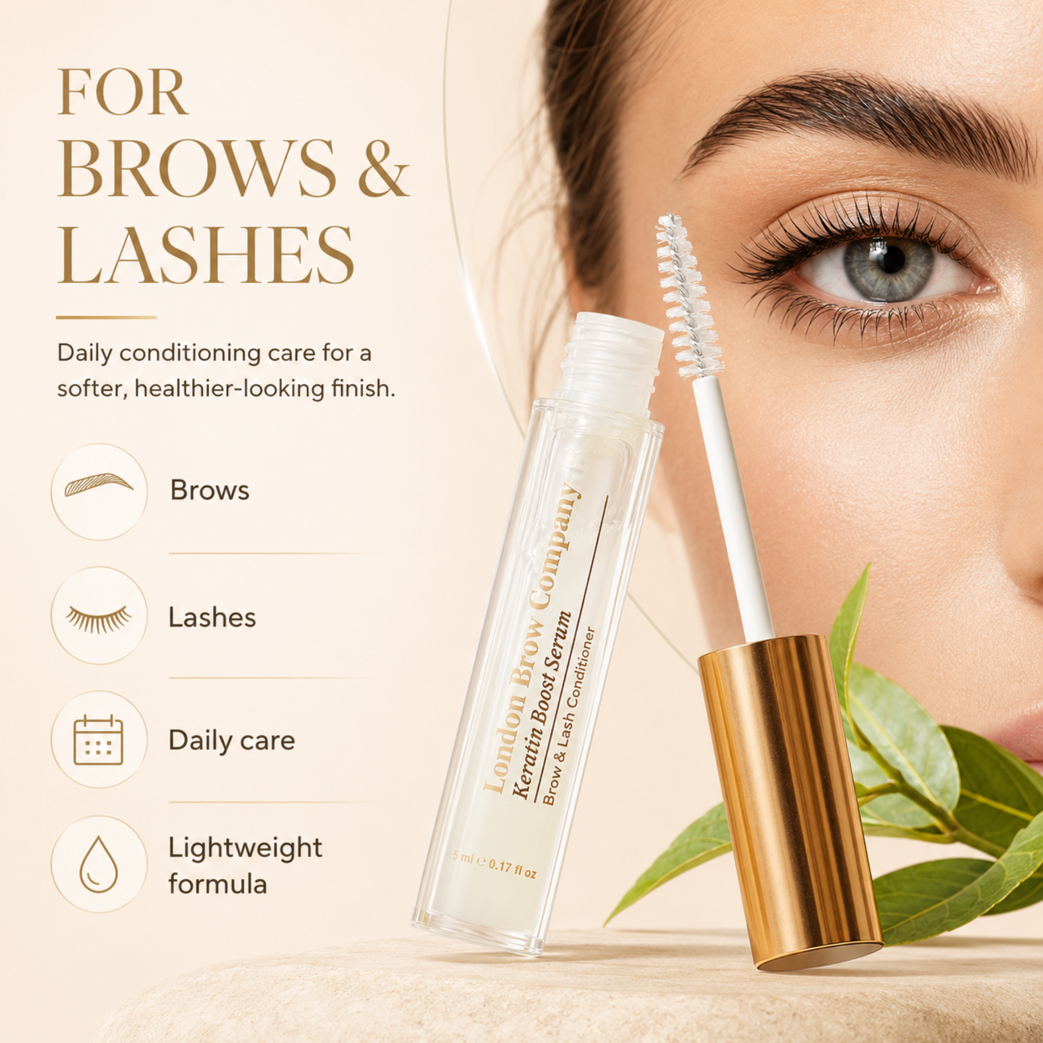 The London Brow Company Keratin Brow & Lash Boost Serum flatlay product shot showing clear serum tube with gold cap spoolie brush and brow comb from overhead angle on white plate with green foliage