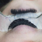 Close-up of eyelash extension application.