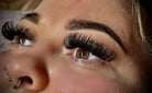 Close-up of a person's eyes with long, voluminous eyelashes, showcasing the product's use.