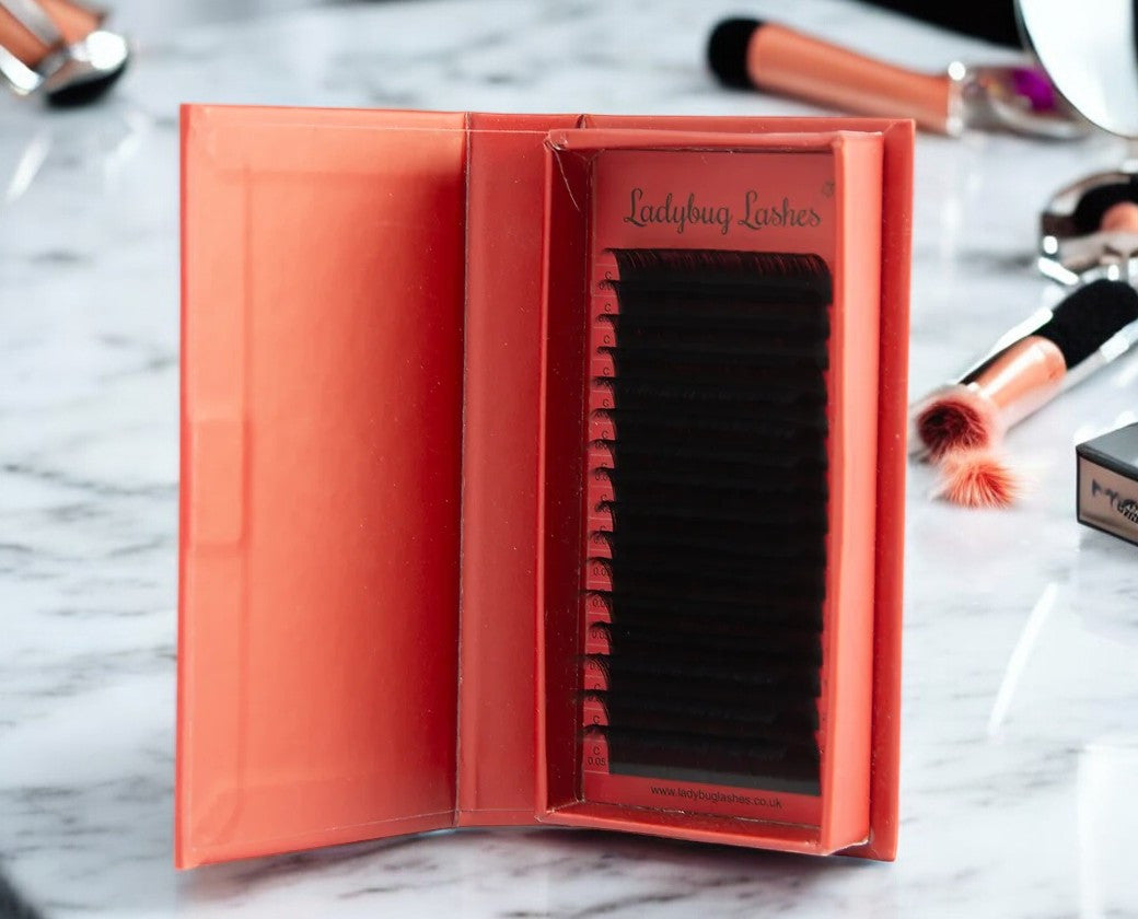 Close-up of a person's eyes with long, voluminous eyelashes, showcasing the product's use.