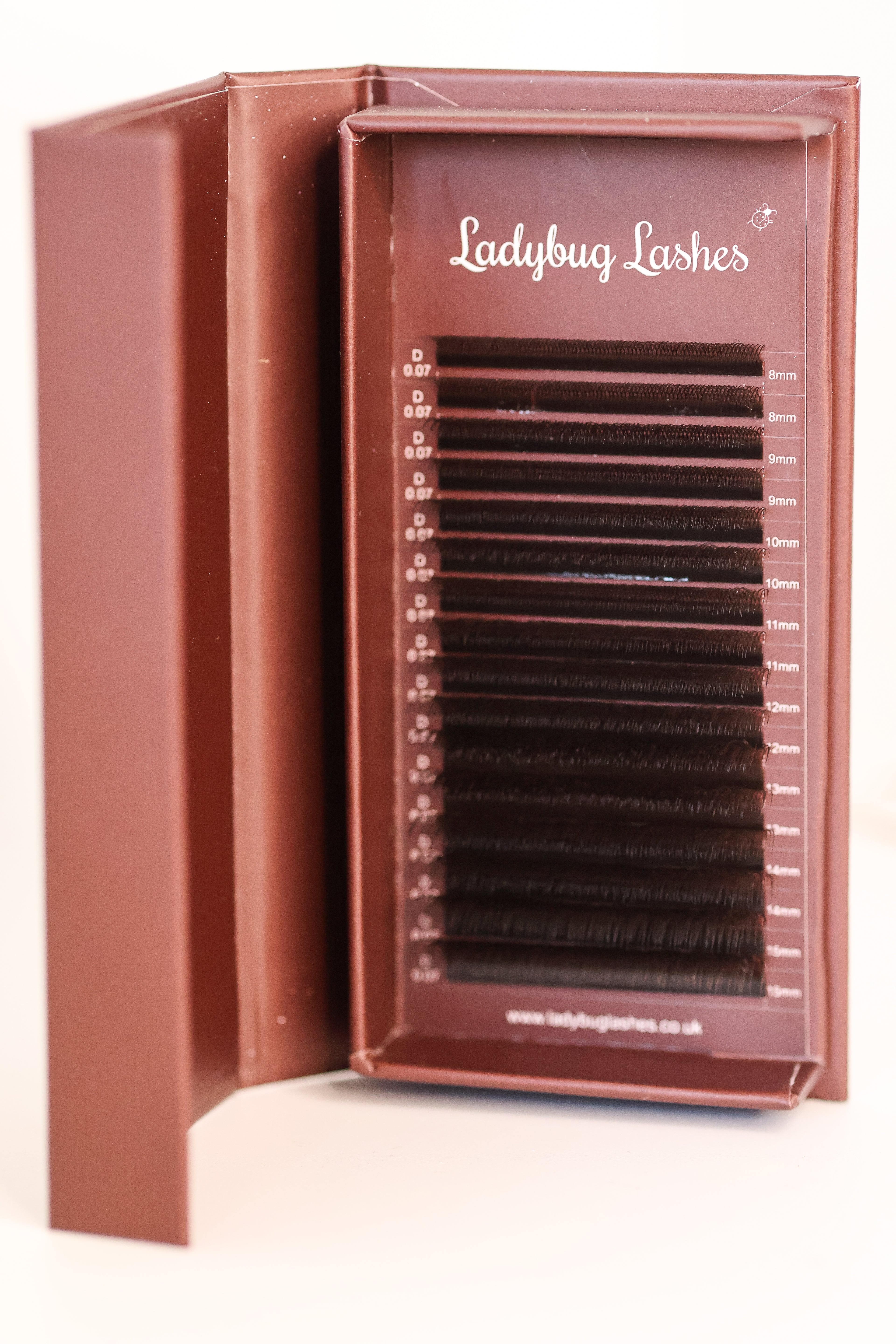Ladybug Lashes Brown W Lash  tray in open branded box showing neat rows of warm brown W-shaped lash extensions front-facing view beautiful brown colour
