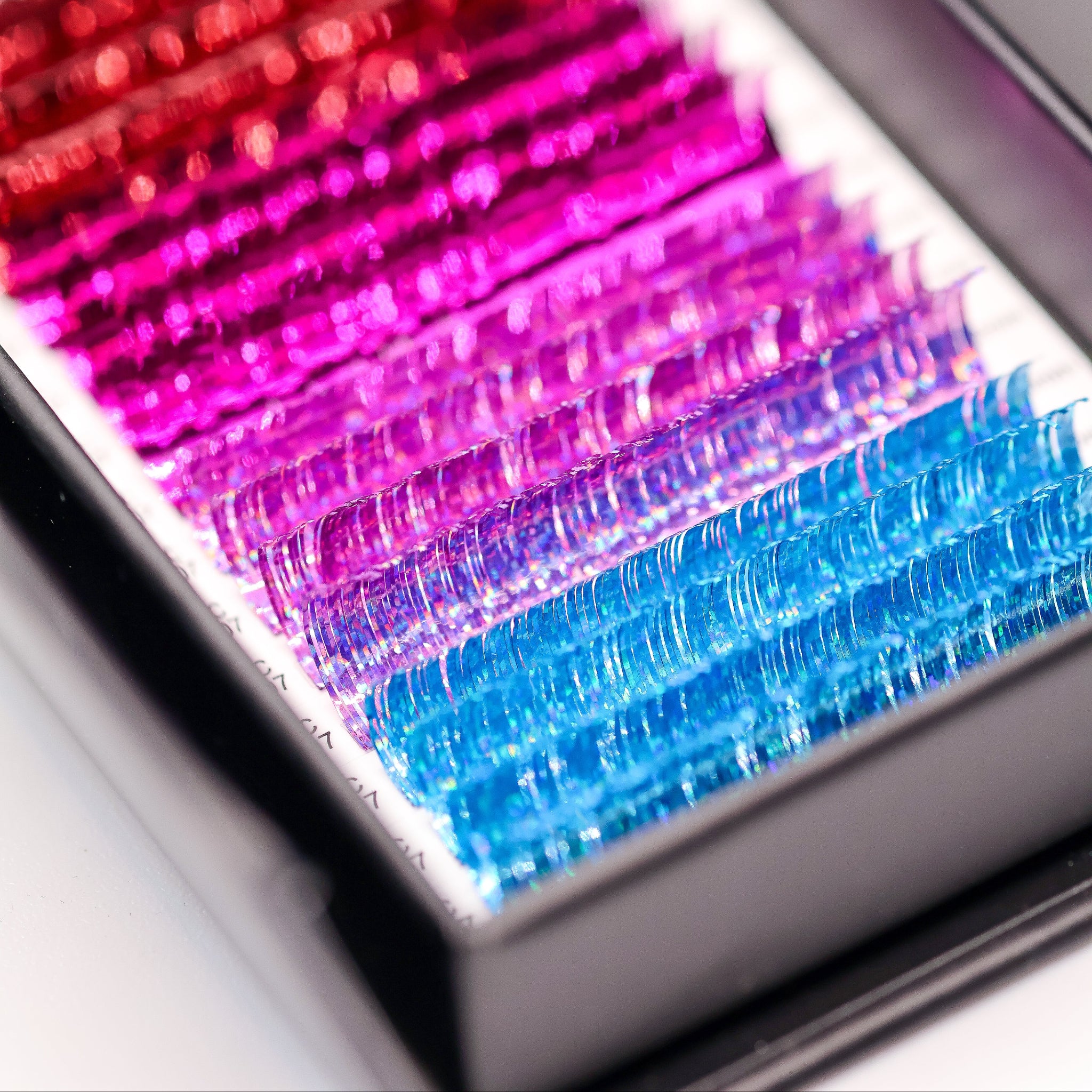 Close-up of Ladybug Lashes YY and Tinsel Lash Collection showing richly pigmented YY lash colour rows from above