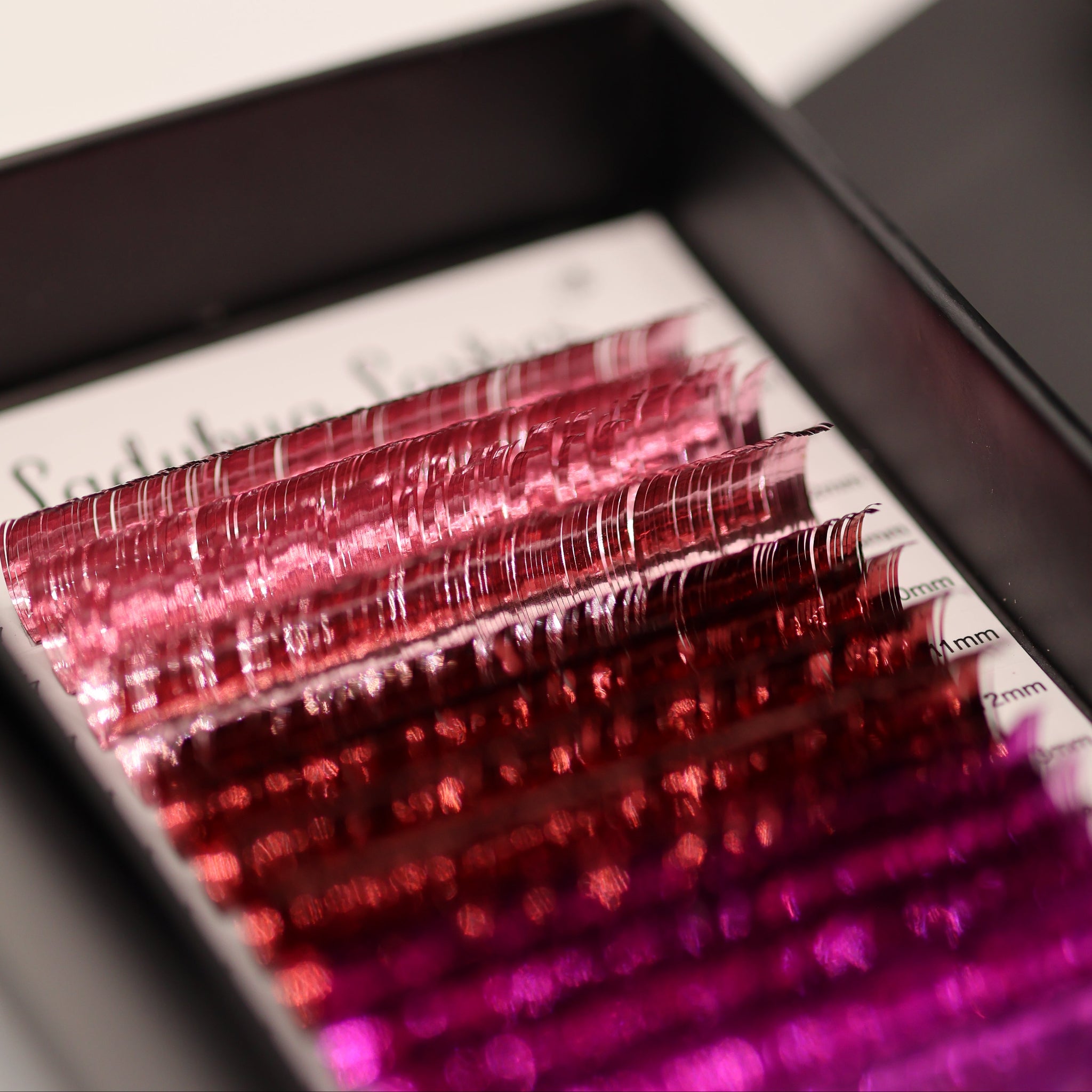 Close-up of Ladybug Lashes YY and Tinsel Lash Collection showing mixed colour and tinsel lash rows from side angle