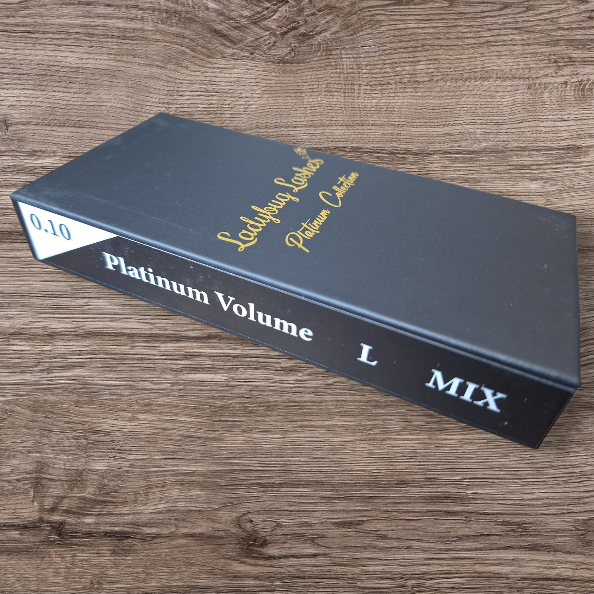 Black box labeled 'Platinum Volume L Mix' on a wooden surface
