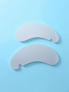 Two white eye patches on a light blue background