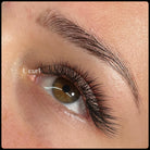 Close-up of completed L curl lash extension set on hazel eye by RoseBellBeauty showing dramatic lift and wispy volume with L curl label overlay