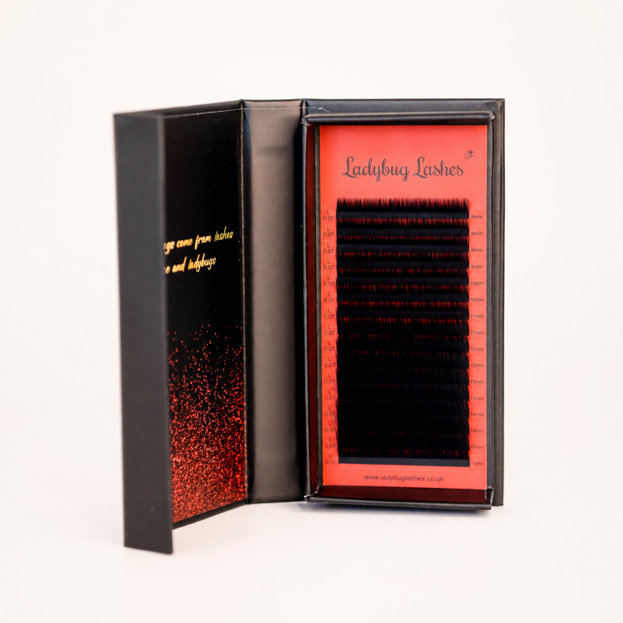 1.	Ladybug Lashes Volume L Curl lash tray open in black and red branded box showing 16 rows of 0.07 black L curl lash extensions from 8mm to 15mm