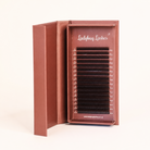 Ladybug Lashes Brown W Lash  tray in open branded box showing full strip of warm brown W lash extensions angled side view