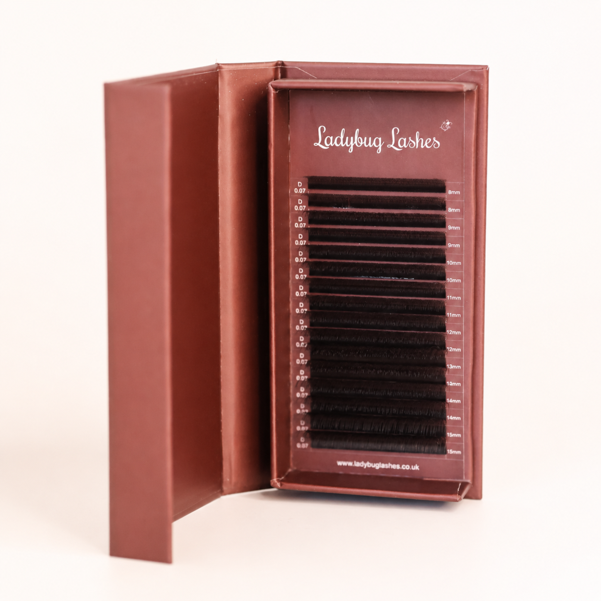 Ladybug Lashes Brown W Lash  tray in open branded box showing neat rows of warm brown W-shaped lash extensions front-facing view