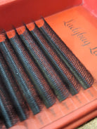 Set of false eyelashes on an red tray with 'Ladybug' branding.