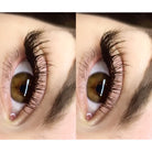 Close-up of a brown eye with long eyelashes on a white background.
