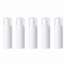 Five white plastic foam pump bottles standing in a row against a white background, each with a white foamer pump head and clear cap — empty refillable bottles sold in a pack of 5 for dispensing lash shampoo as a foaming cleanser for lash extensions and brows