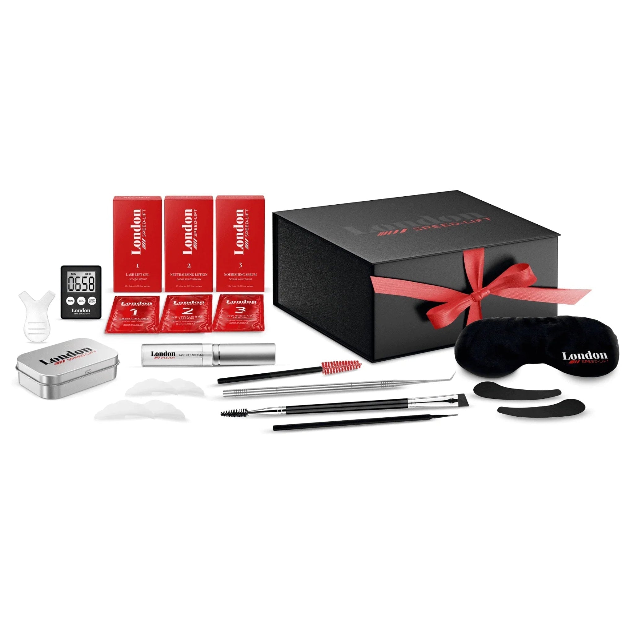 London Brow Company Speed-Lift Lash Lift and Tinting Course full kit flatlay showing black London Speed-Lift branded magnetic gift box with red ribbon bow alongside all kit contents including three red numbered London Speed-Lift solution boxes three red numbered sachets silver branded tin digital countdown timer lash serum bottle stainless steel lash rod tool dual-ended brush pen spoolie red mascara wand black 