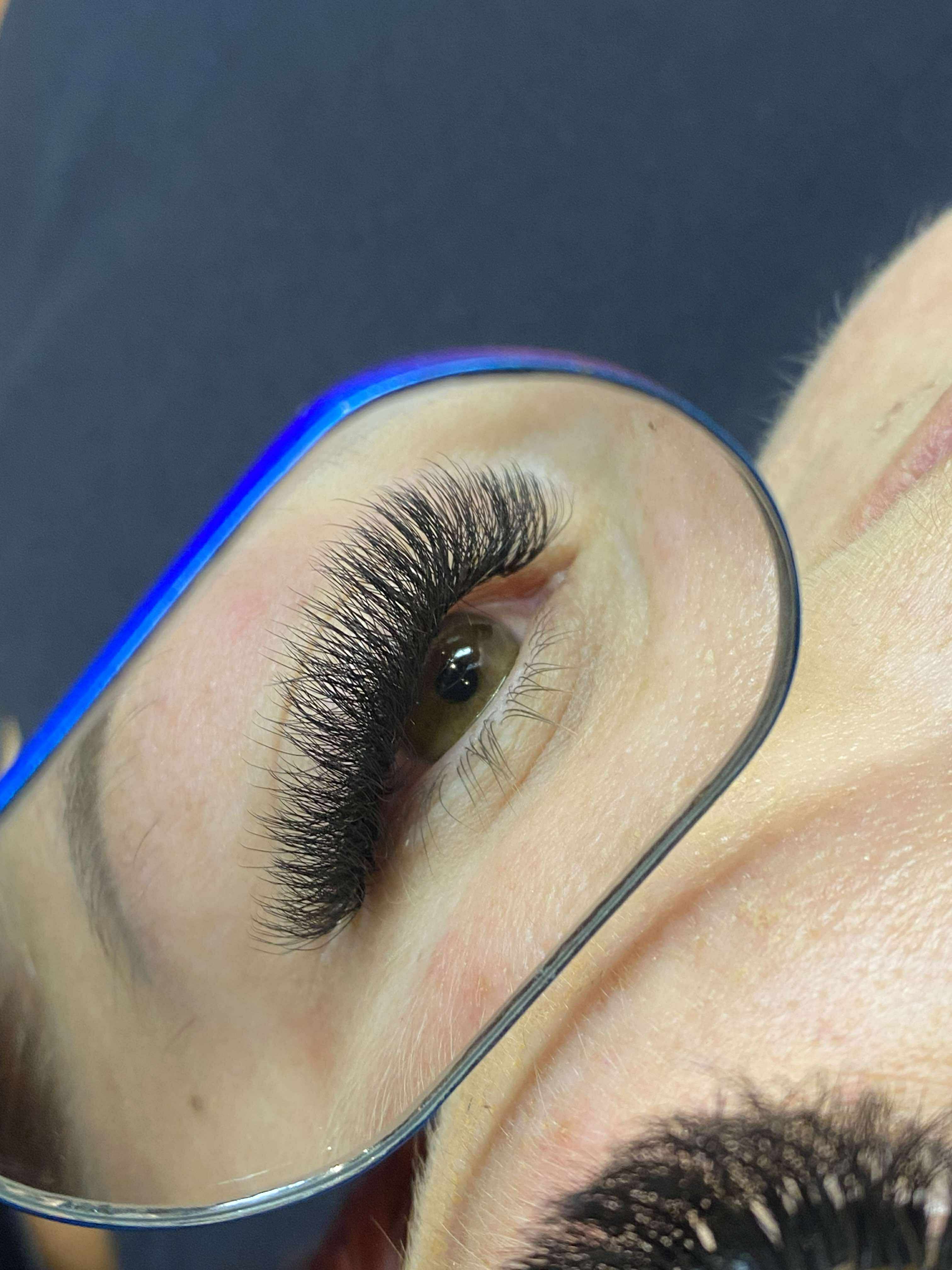Eyelash extension being applied with a blue mirror