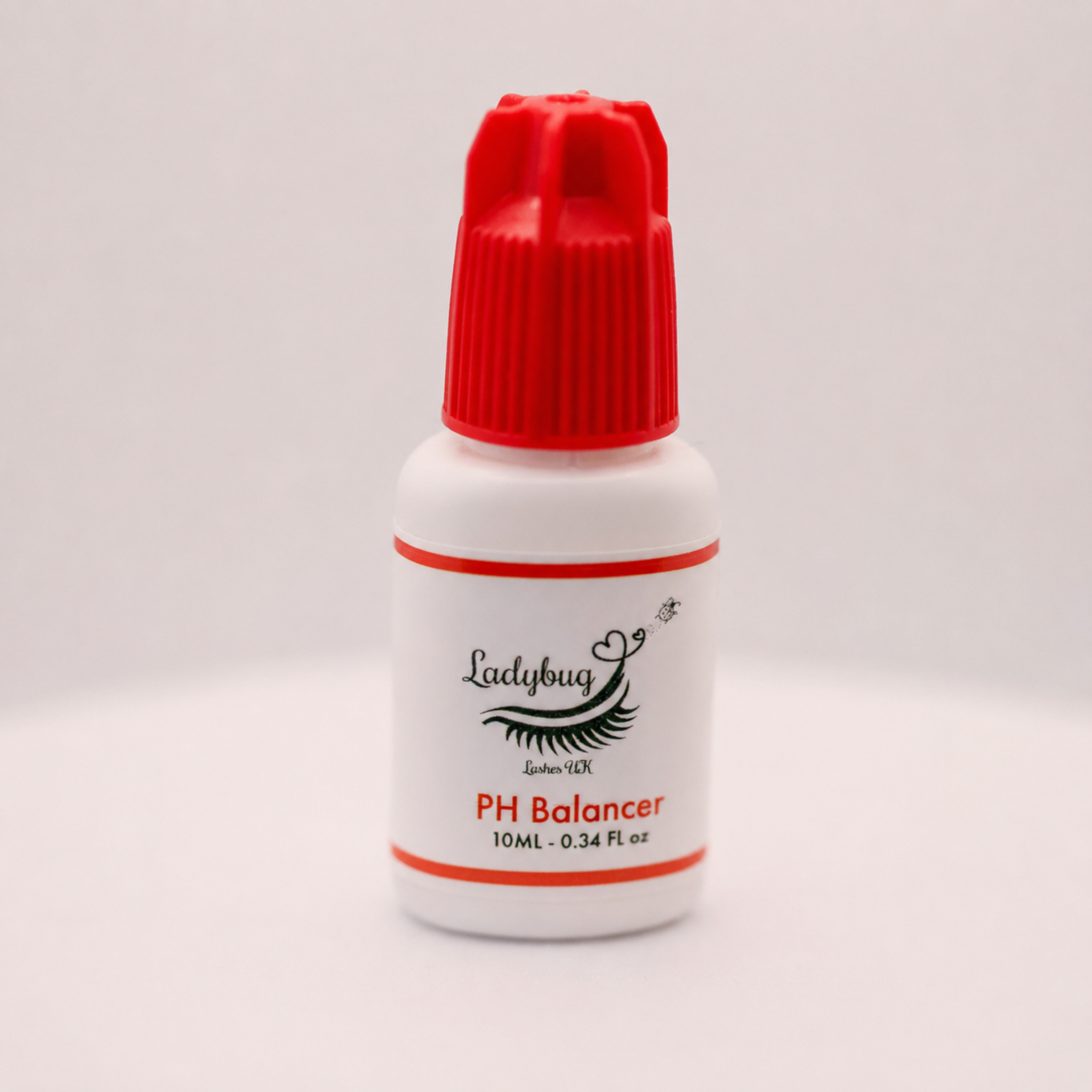 Ladybug Lashes PH Balancer Primer 10ml white plastic bottle with red cap showing product label with Ladybug Lashes UK branding and 10ML 0.34 FL oz size detail on a light grey background