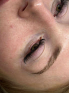 Close-up of a person's eye with visible eyelashes and eyebrow.