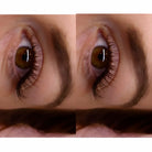 Close-up of a brown eye with eyelashes and eyebrows.
